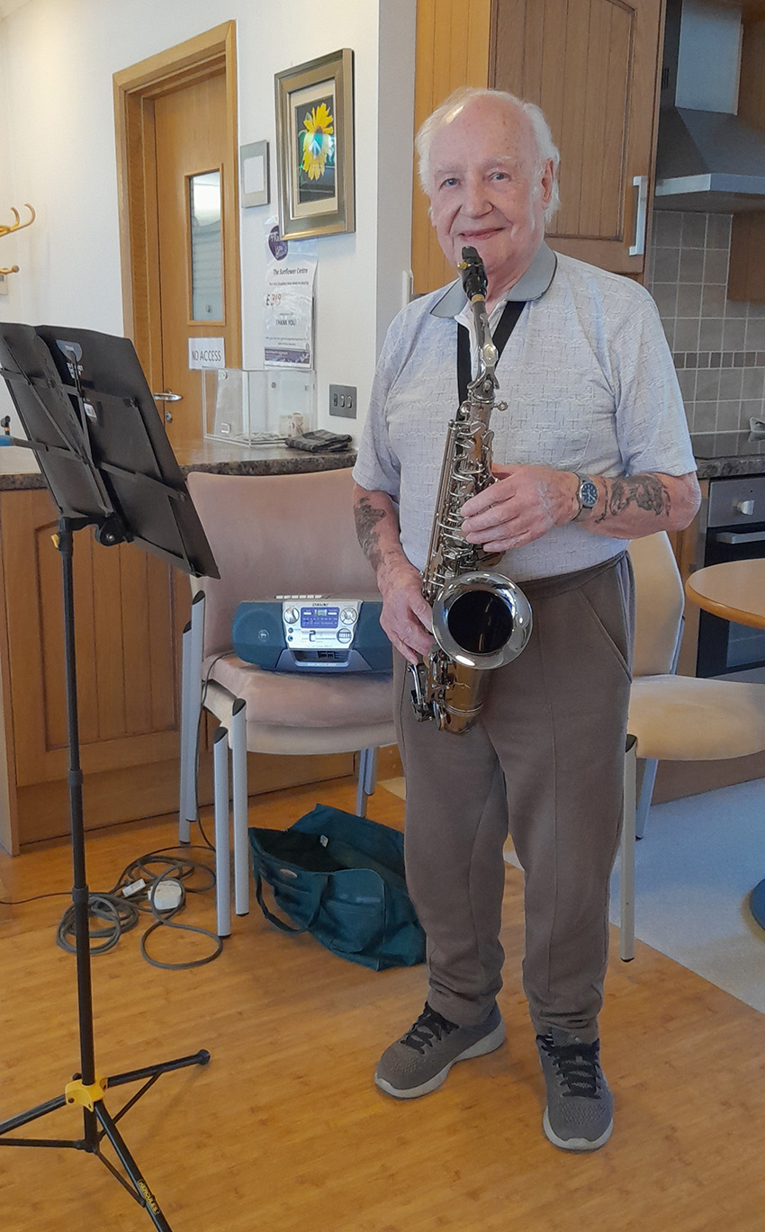Merv playing saxophone at the Sunflower Centre in St Margaret's Hospice