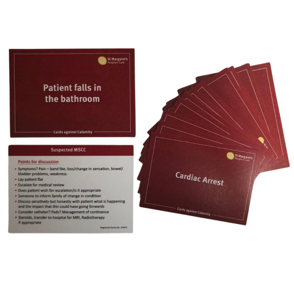 Two cards from a game lay flat with a pile of cards next to the,.