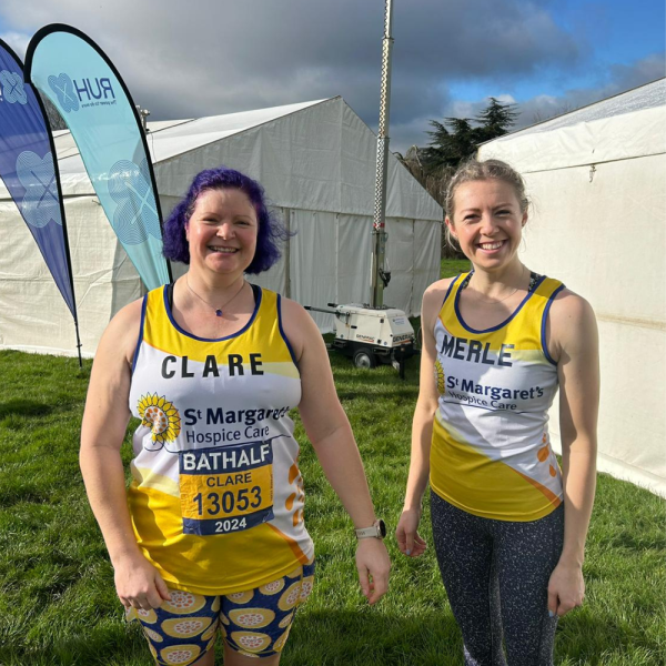 two females in a field wearing St Margaret's technical running vests