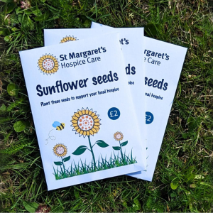 x3 packets of sunflower seeds on a grass background