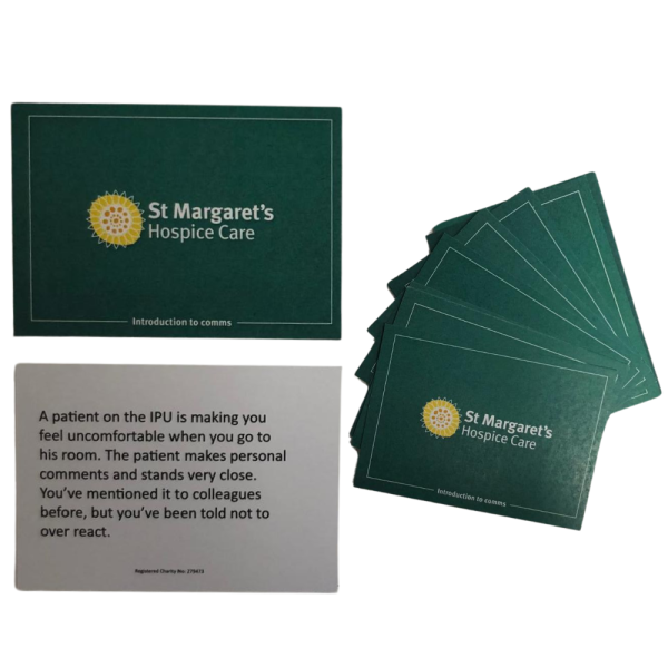Two cards lay flat alongside a stack of cards spread into fan.