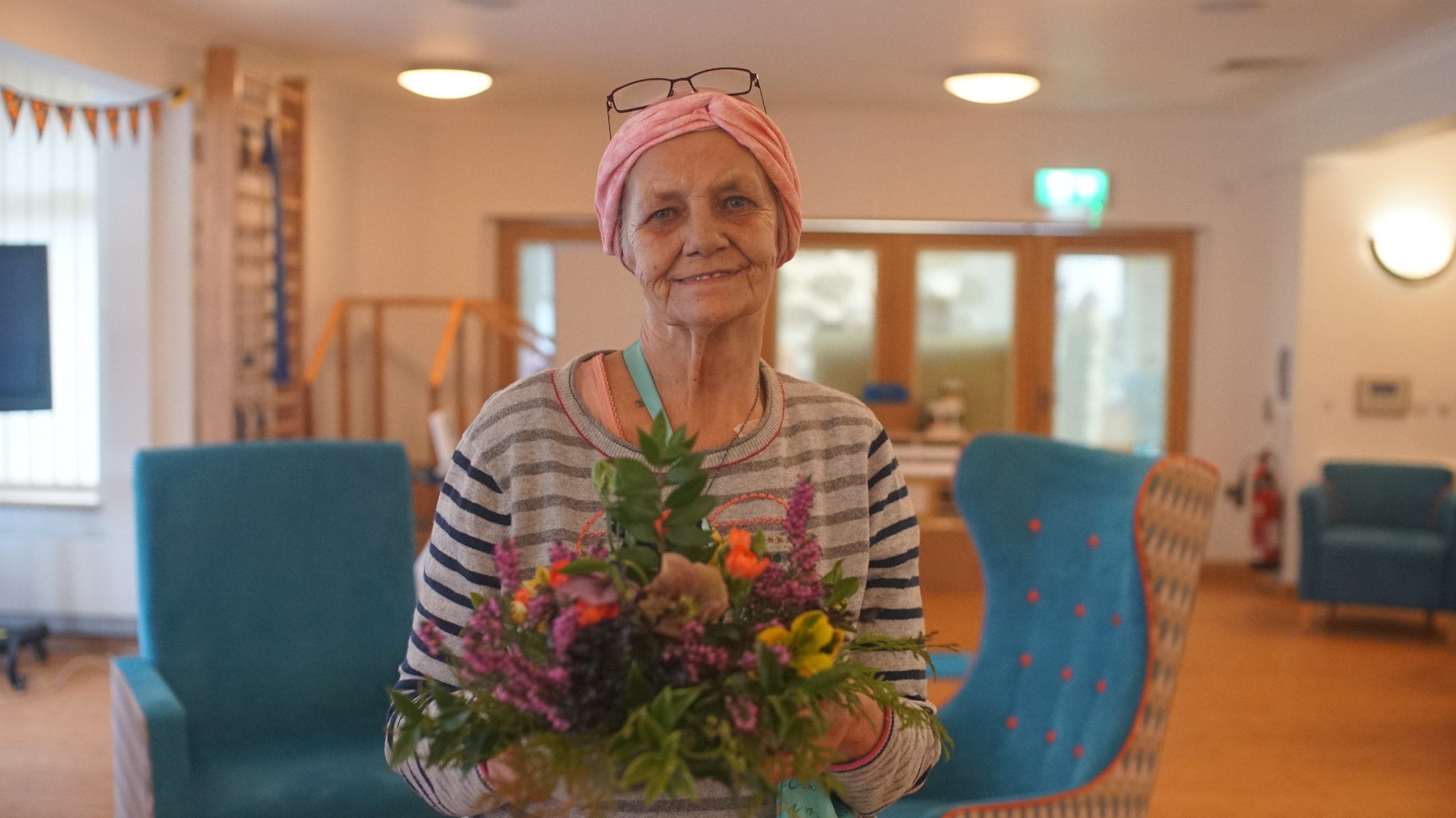 Female with flower arrangement in front of her