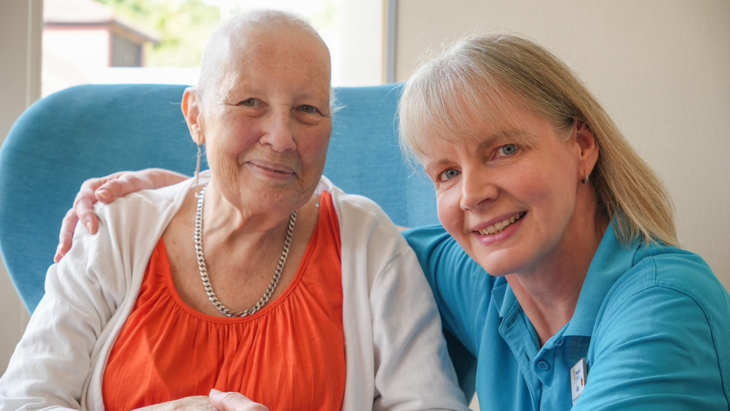 Nurse with a patient smiling at the camera
