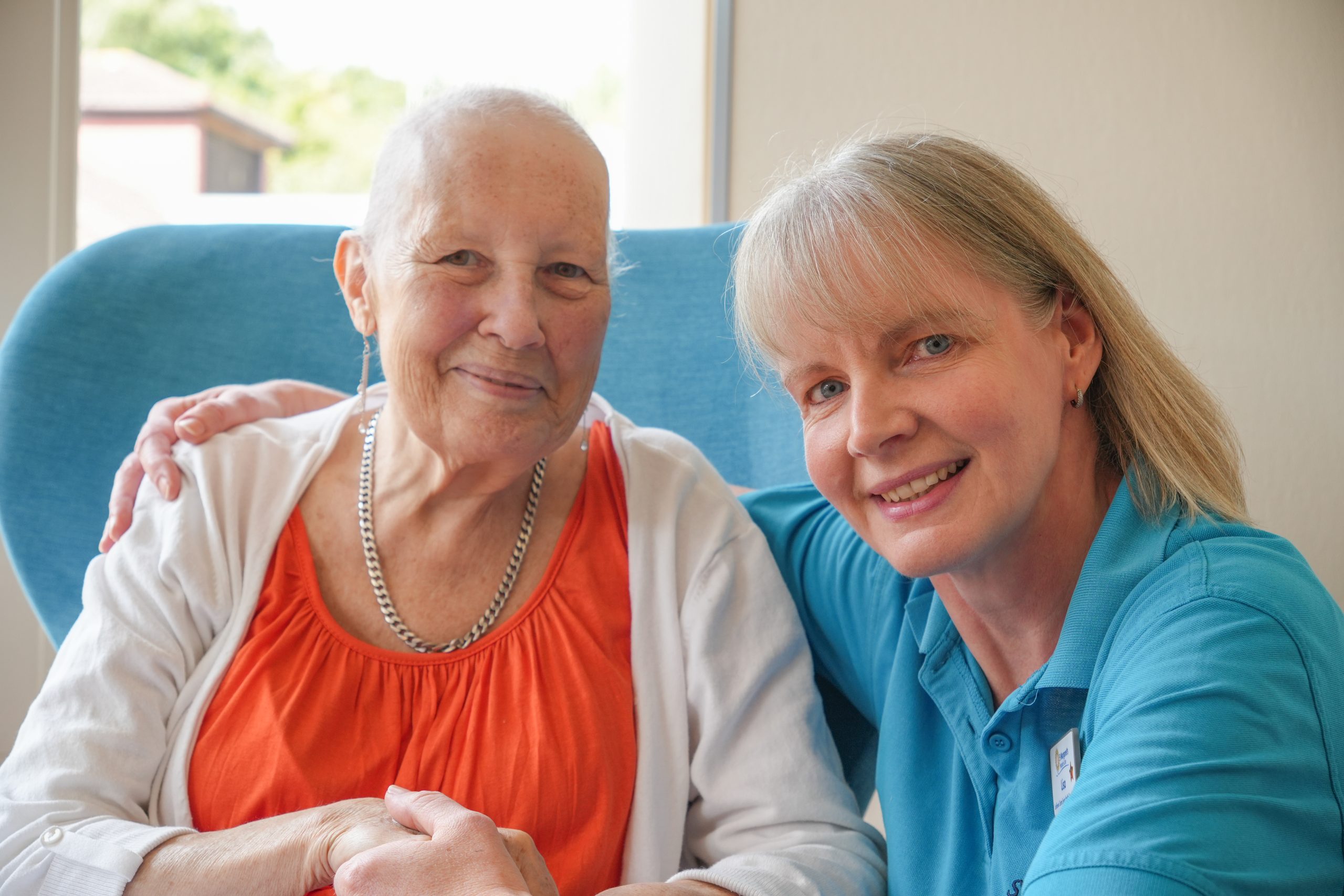 female health care professional with female patient -both smiling to camera