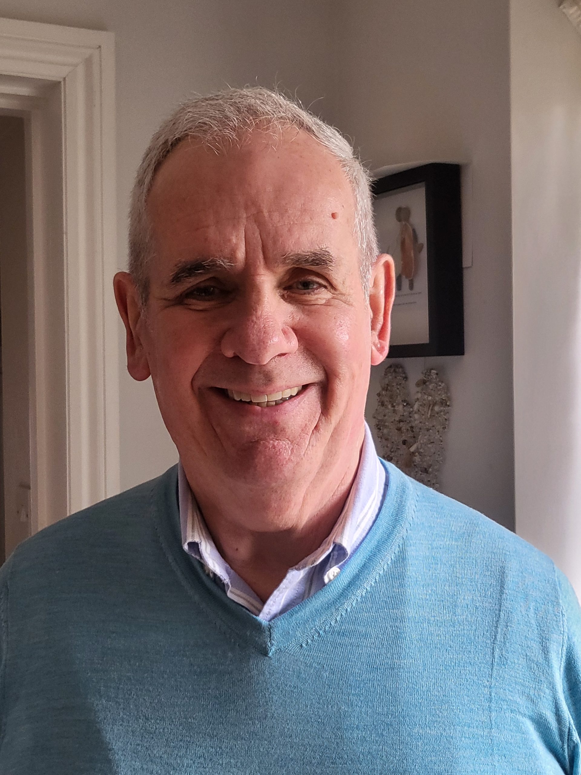 Male smiling to camera in home setting