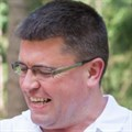 Pat Colton - male laughing away from camera