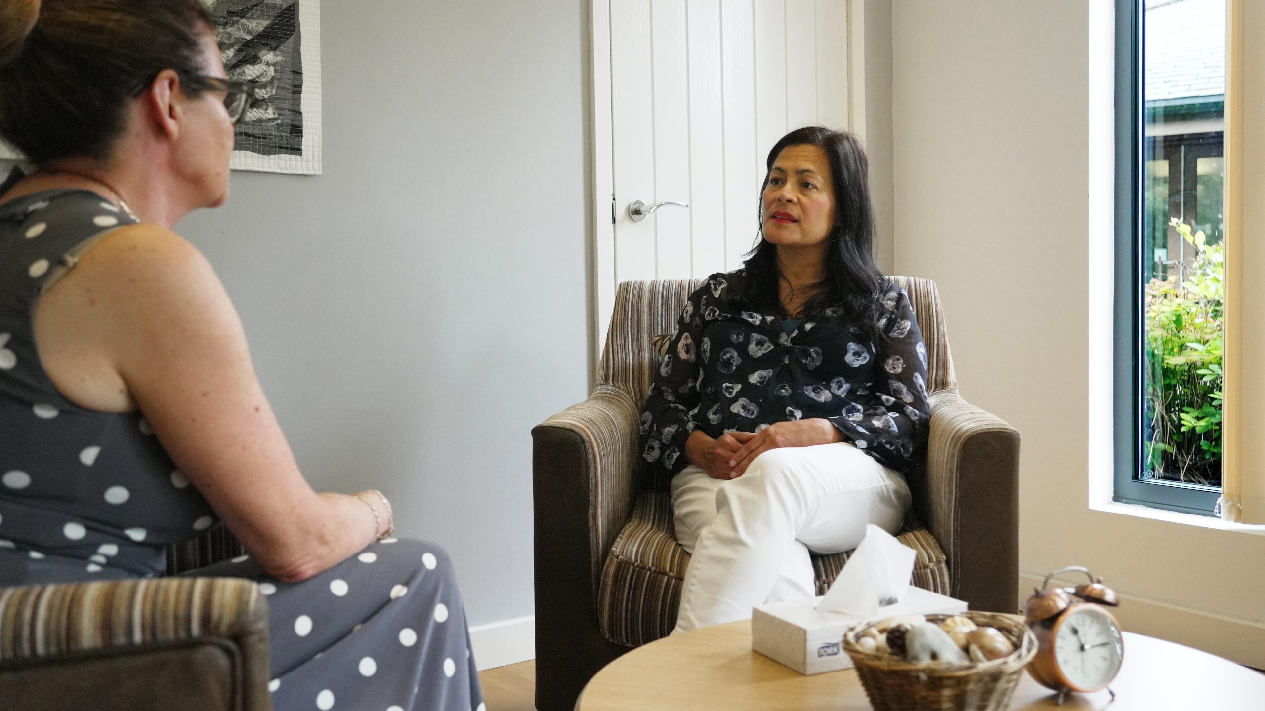 Two ladies sat in a bereavement lodge