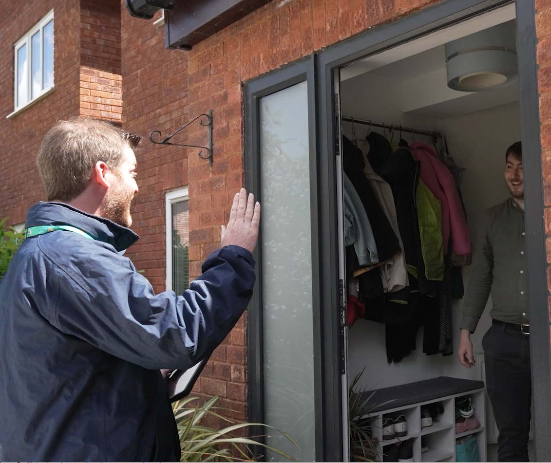 male at door with another male