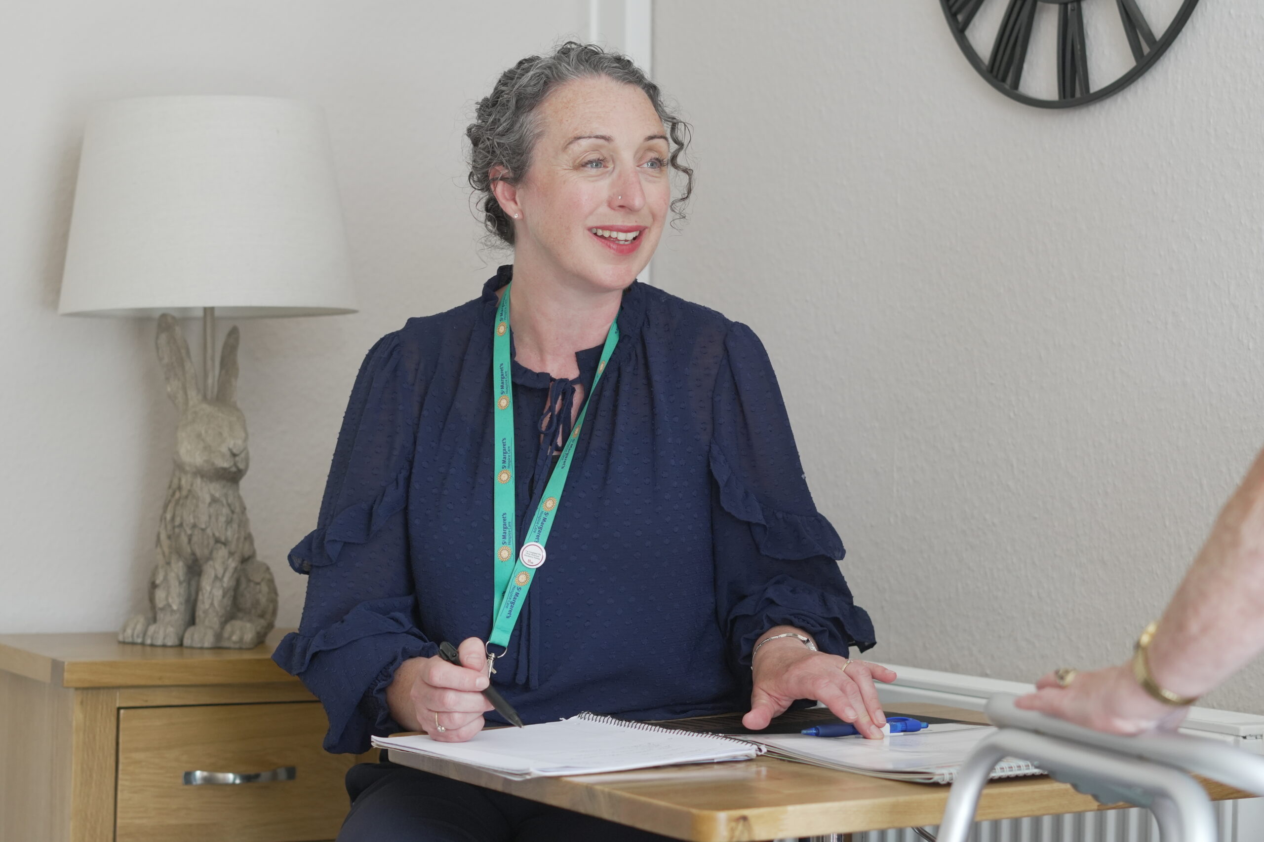 A specialist palliative nurse visiting a patient in their home.